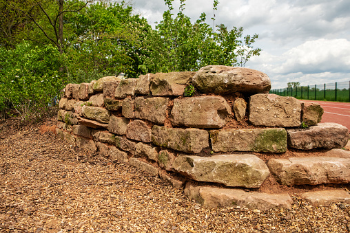 self-built wall made of natural sandstone as a biotope for insects