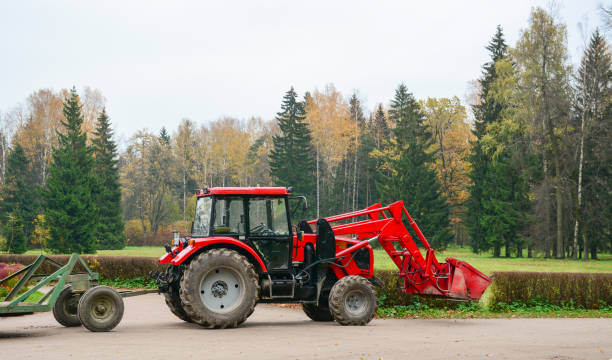 Red tractor on agricultural field, plowing. Lugo province, Galicia, Spain.