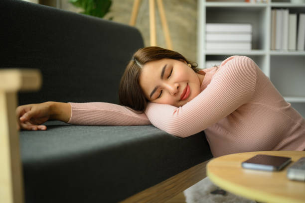 istock Serene young asian woman leaning on sofa, taking a break during remote work day at home. 1499689997