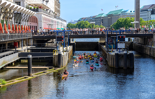 Low angle view of people into kayak, Hamburg downtown - Schleusenbrücke - Down town Watergate at Alster river