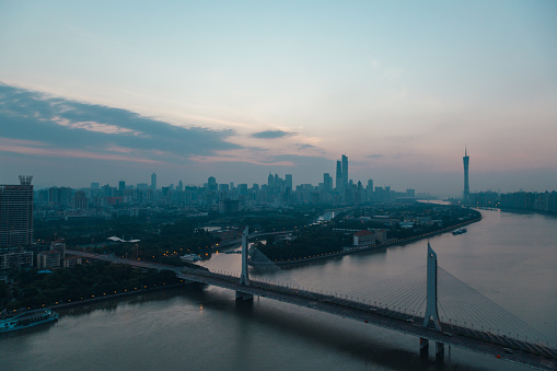 Sunrise photo of Guangzhou City central area from high angle over looking Hai Yin Bridge, Er Sha Island, pearl river and Zhu Jiang New Town.