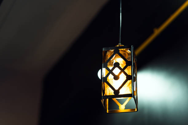 istock Square lamp with golden light hanging from the ceiling. Home decoration ideas. 1499691039