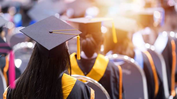 istock Graduate wearing the cap and gown during the ceremony 1499696877
