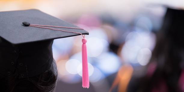 istock Graduate wearing the cap and gown during the ceremony 1499696883