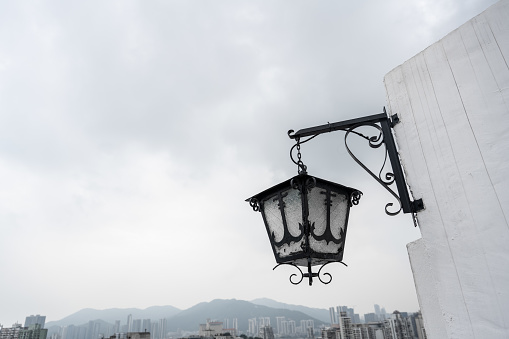 Glowing vintage street lamp with two lamps at night, outdoors