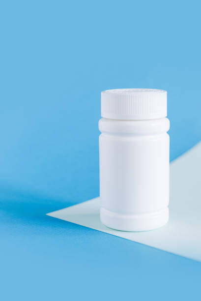 istock white medicine bottle mockup on blue background, pill bottles without label design, copy space 1499700570