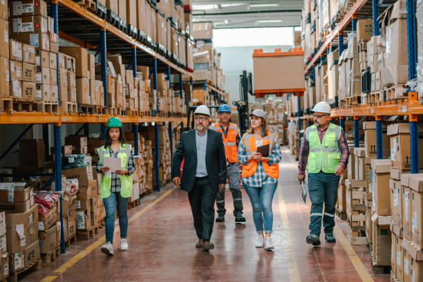 istock Collaborative Innovation: Brainstorming and Discussion in Factory Warehouse Corridor 1499702167