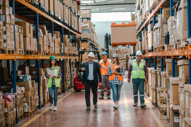 istock Collaborative Innovation: Brainstorming and Discussion in Factory Warehouse Corridor 1499702169