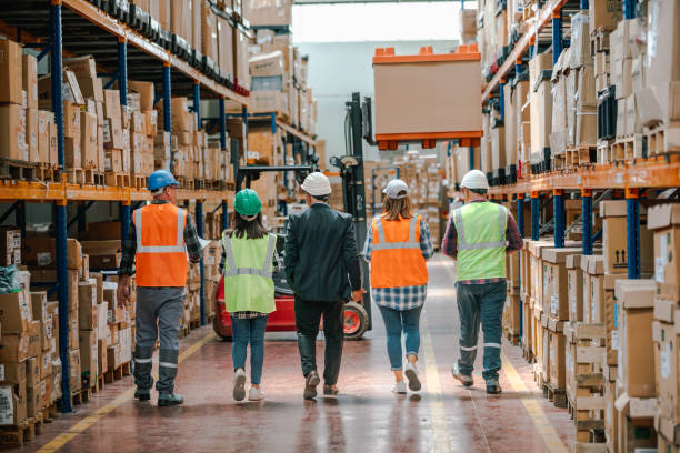 istock Collaborative Innovation: Brainstorming and Discussion in Factory Warehouse Corridor 1499702514
