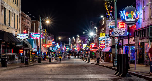 Memphis, Tennessee, USA. 6 June 2023. Neon signs of bars and music venues on Beale Street at night, Memphis. People walking on the street.