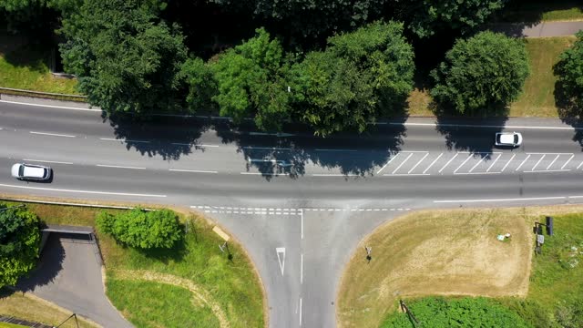 Straight down aerial drone footage of a main road t-junction from above showing the road in the town of Otley in Leeds West Yorkshire showing the road junction from above on a sunny day in the summer