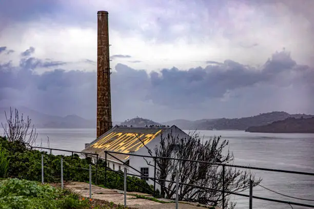 Photo of Building with the word Alcatraz on the roof of the maximum security federal prison of Alcatraz in the bay of San Francisco, in the state of California, United States of America.