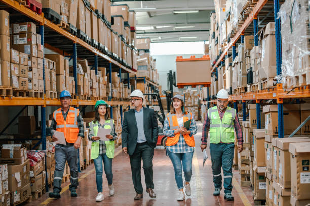 istock Collaborative Innovation: Brainstorming and Discussion in Factory Warehouse Corridor 1499707447