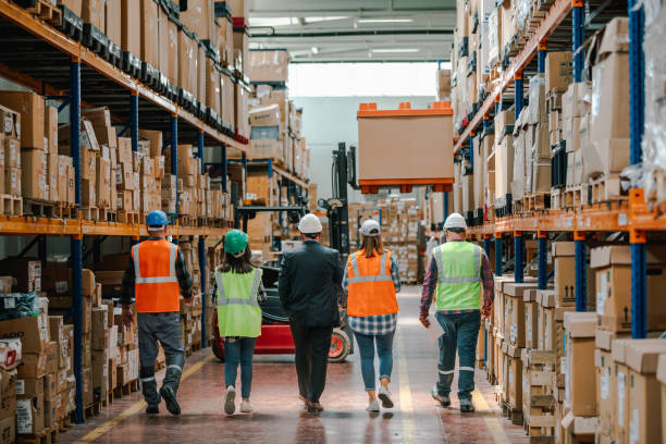 istock Collaborative Innovation: Brainstorming and Discussion in Factory Warehouse Corridor 1499707514