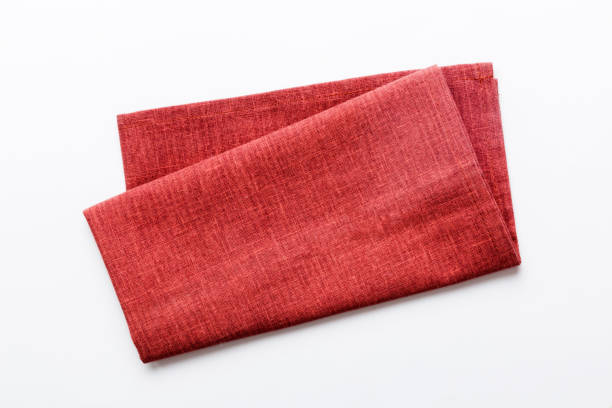 istock top view with red empty kitchen napkin isolated on table background. Folded cloth for mockup with copy space, Flat lay. Minimal style 1499708115