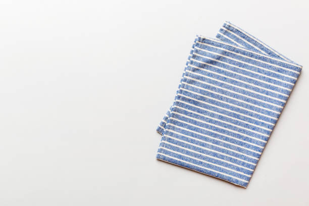 top view with blue kitchen napkin isolated on table background. Folded cloth for mockup with copy space, Flat lay. Minimal style