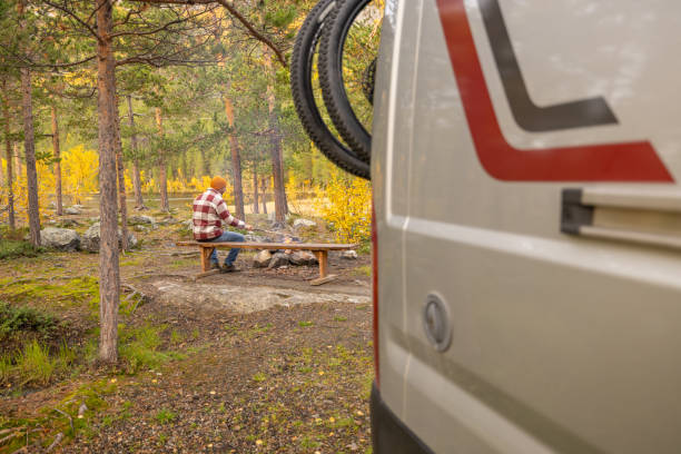 istock Man making fire at campground, van life concept 1499708224