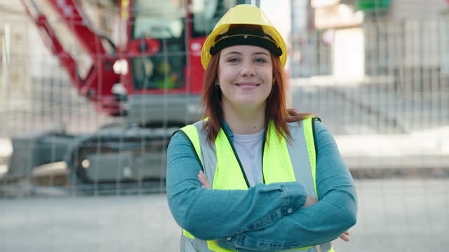 Young beautiful plus size woman architect smiling confident standing with arms crossed gesture at street