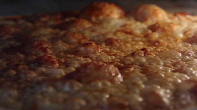 Close-up of a pizza baked in the oven, melting and seething
