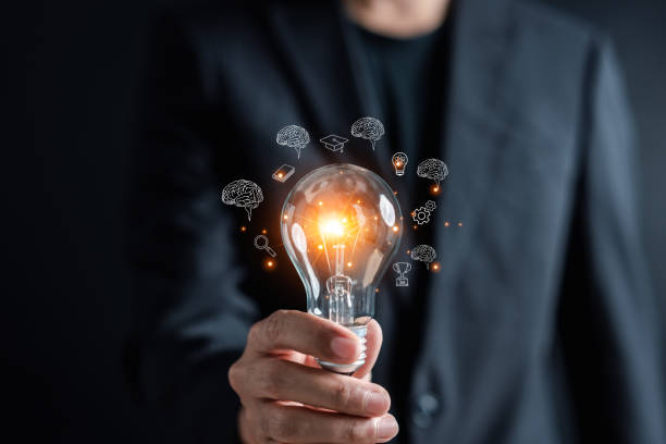 istock Man holding illuminated lightbulb glowing to Starting New idea, innovation and inspiration, smart intelligent creativity, Motivation and innovation concept. 1499714075