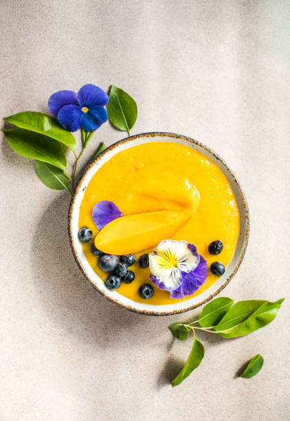 istock Mango Lassi, smoothie  bowl with turmeric. Fresh tropical fruit on a light  background. Healthy food 1499714177