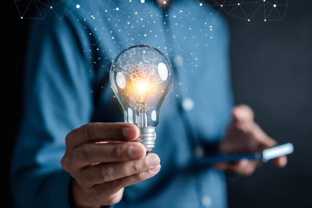istock Man holding illuminated lightbulb glowing to Starting New idea, innovation and inspiration, smart intelligent creativity, Motivation and innovation change world. 1499714951