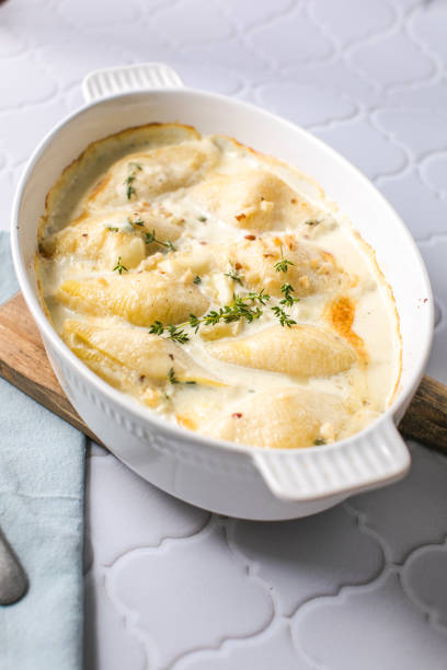 istock cheesy and creamy chicken and shells pasta bake in baking dish on dark grey concrete table, horizontal view from above, close-up 1499715117
