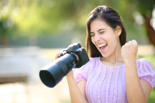 Close up of a man uses a film camera on the street.