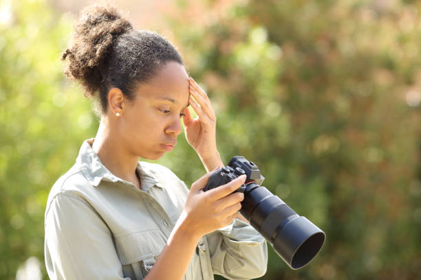 istock Worried black photographer checking camera 1499715951