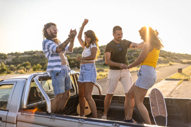 istock Couples having fun on pick-up truck 1499716110