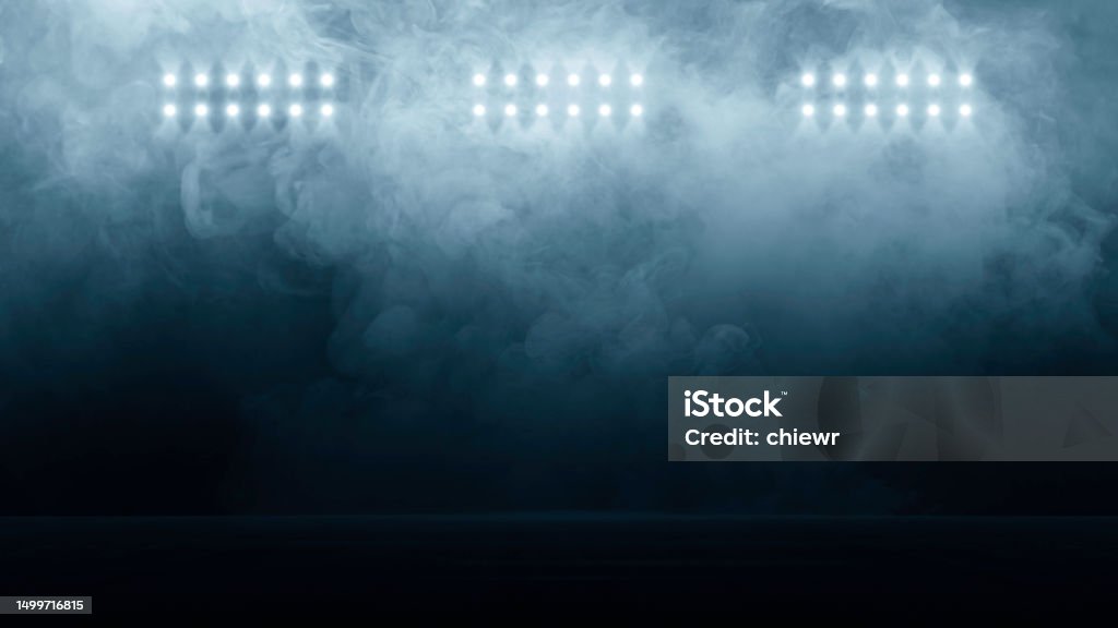 Bright stadium arena lights, Smoke bombs, empty dark scene, neon light, spotlights The concrete floor and studio room with smoke float up the interior texture, night view for display products Soccer Stock Photo