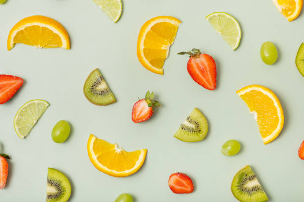 istock Citrus fruits and strawberries, pattern flat lay, top view.  Summer layout on colored background 1499716968