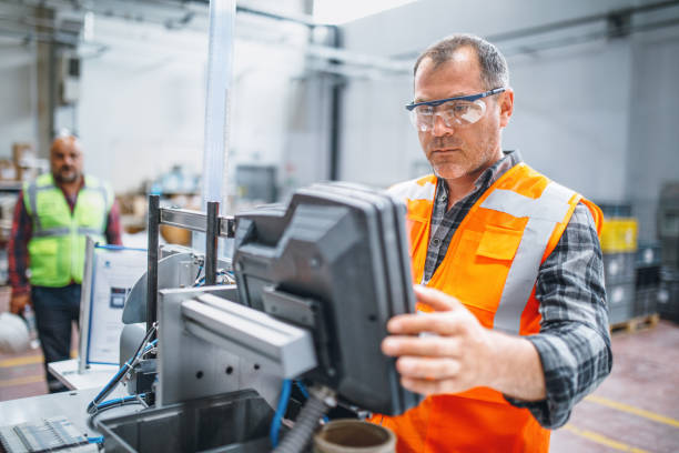 istock Manual worker man working at manufacturing factory 1499718347