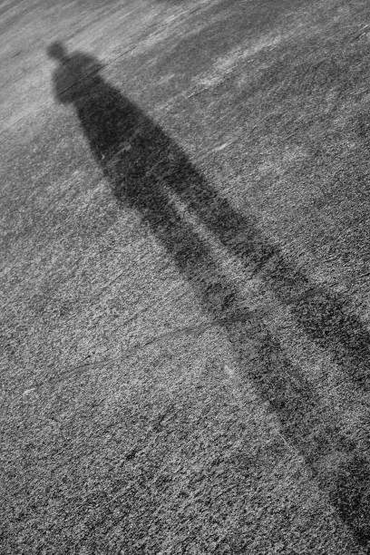 Woman standing shadow on the concrete floor.
