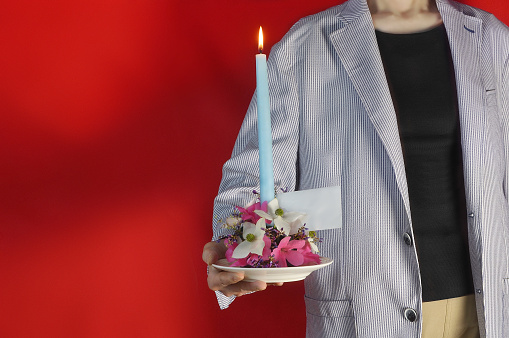 Woman Holding Flower Arrangement & Candle/Studio Shot