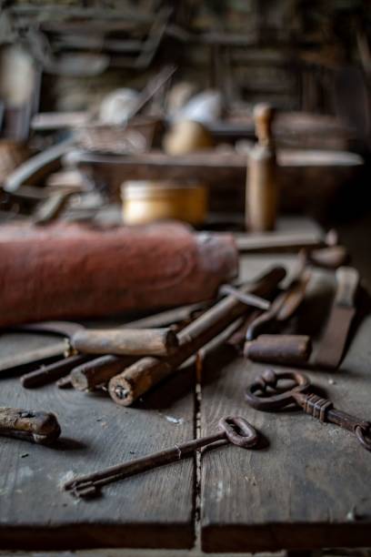 istock Vertical closeup of old rusty industrial tools on a wooden table in a workshop 1499722777