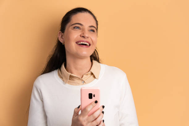istock cheerful woman checking smartphone 1499723142