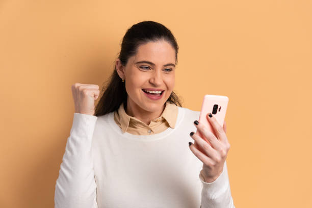 istock fun woman looking at mobile cell phone 1499723248