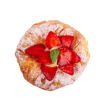 Delectable strawberry puff pastry garnished with mint leaves, set against clean white backdrop