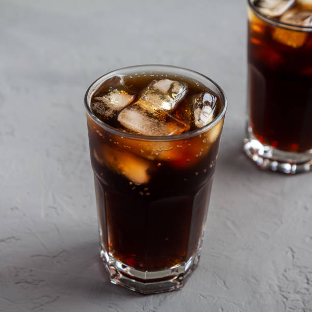 istock Cold Refreshing Dark Cola with Ice Cubes on a gray background, low angle view. 1499725975