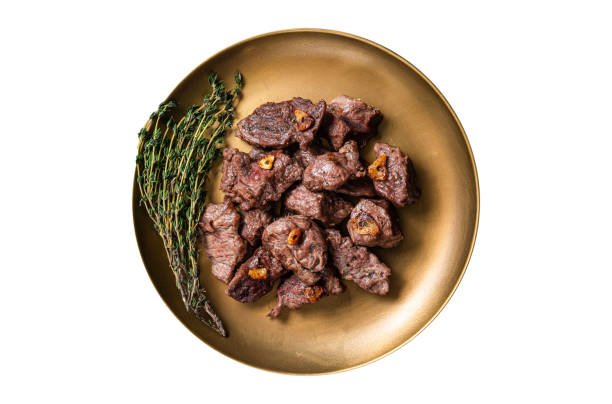 istock Chopped Grilled Diced Beef garlic steak on a plate with thyme. Isolated on white background. 1499726935