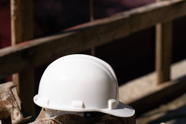 istock Close-up of a white helmet lying on metal structures on a construction site, safety precautions. 1499727059