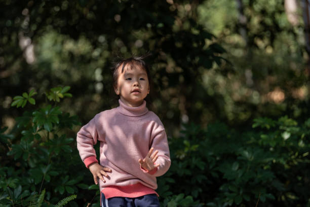 istock A little girl is doing gymnastics exercises under a tree 1499728286