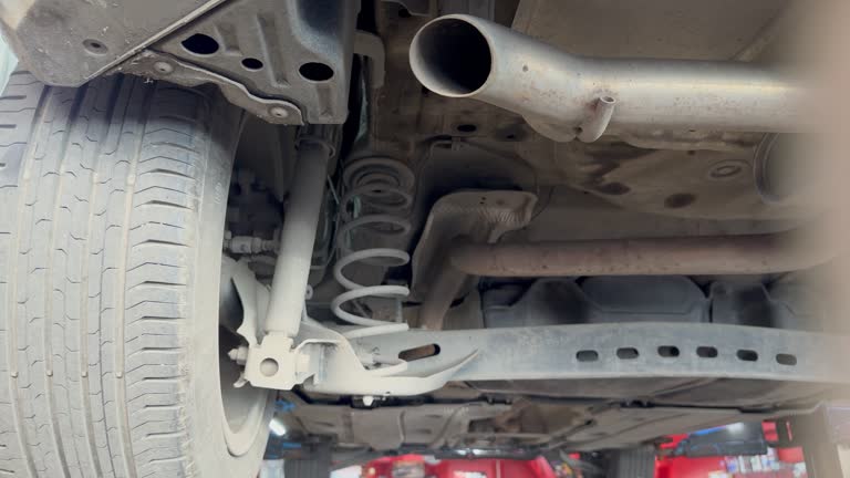 View under the car at the service station. Video. Bottom view of a car suspension at the service center, car maintenance stock video