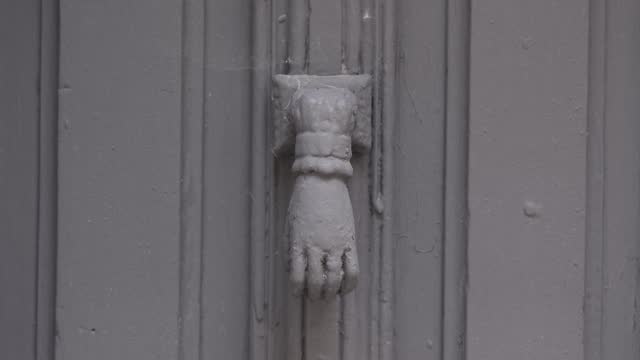 Antique grey hand door knocker