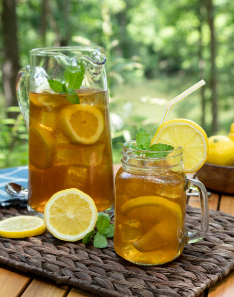 istock Ice tea in glass jar and pitcher with lemon and mint 1499729635