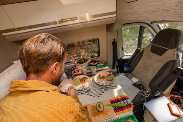 istock Man preparing food inside his camper van. Camping concept 1499730804