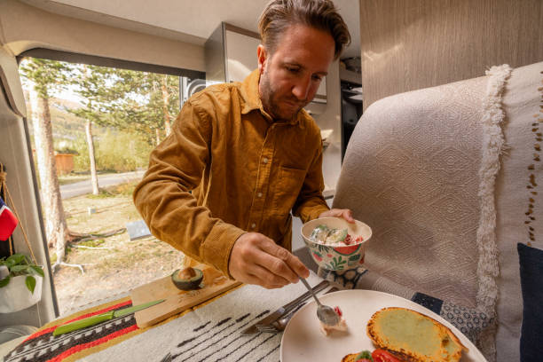 istock Man preparing food inside his camper van. Camping concept 1499730854