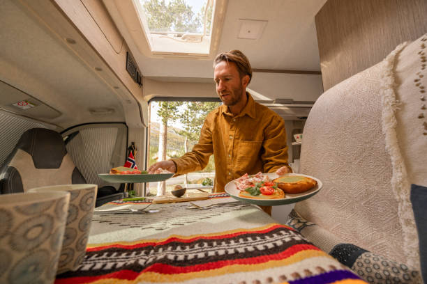 istock Man preparing food inside his camper van. Camping concept 1499730984