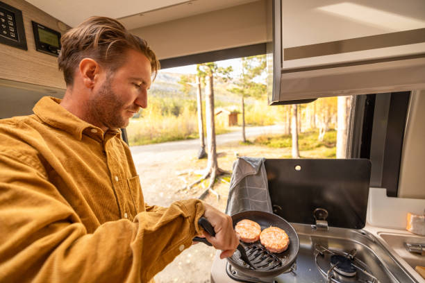 istock Man preparing food inside his camper van. Camping concept 1499731181